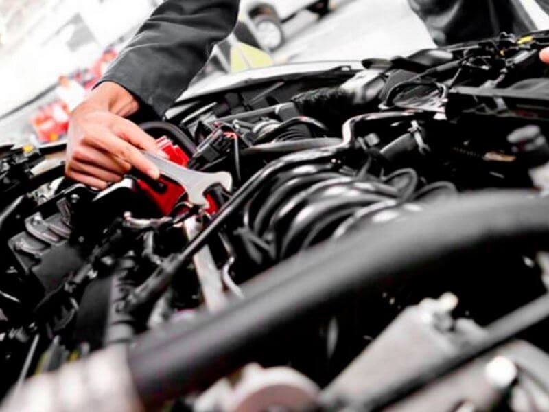 Work on a car engine.