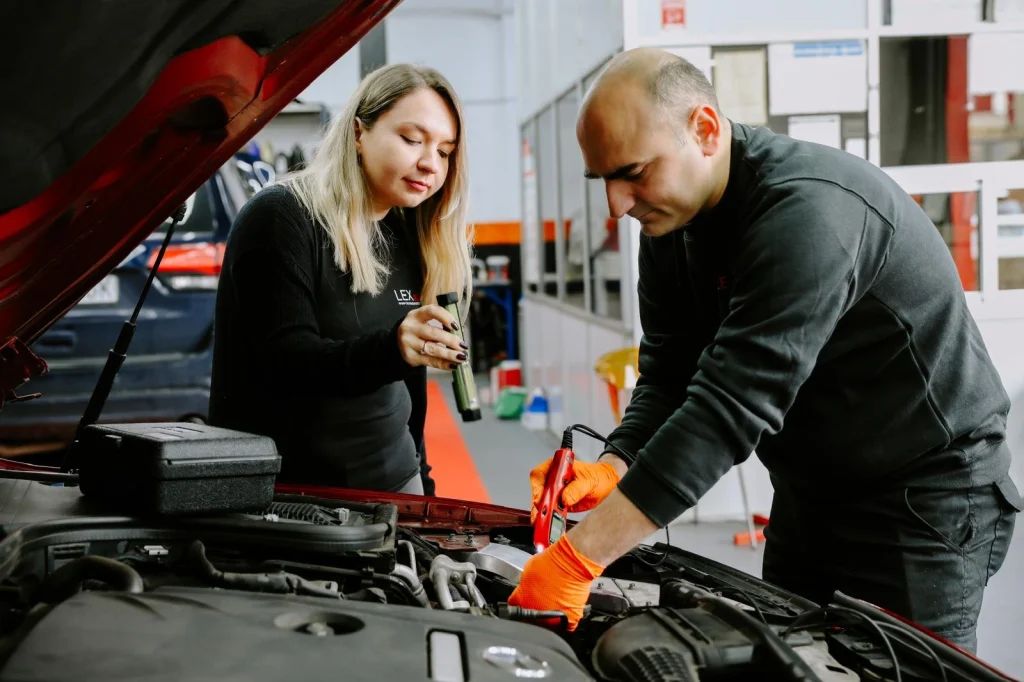 The owners of Lexauto Madrid checking a car engine.